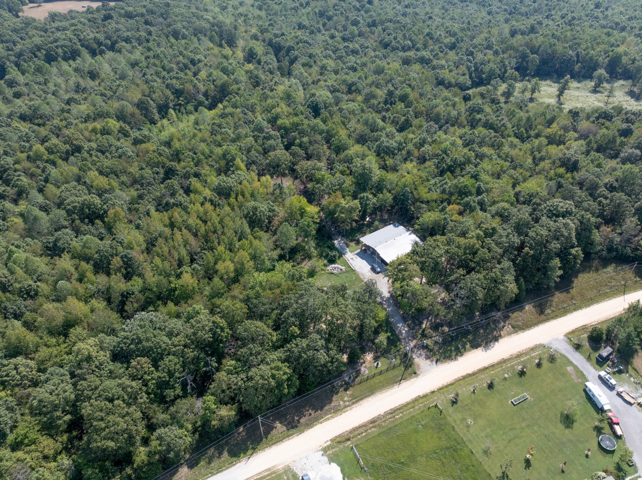 3844 Humphreys County Line Road Dickson, TN 37055 - Photo 37 of 57 a view of a forest with a sink and yard