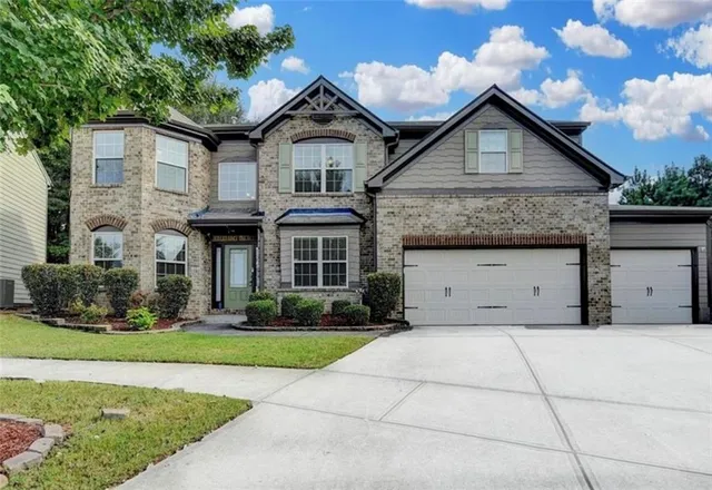 a front view of a house with garden