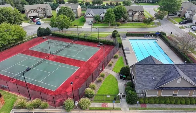 an aerial view of a tennis ground with large trees