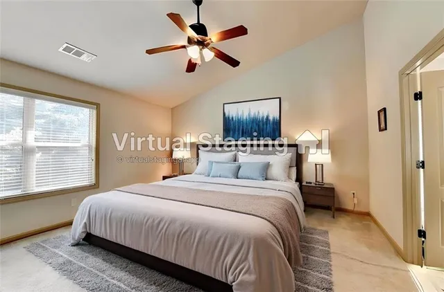 a bedroom with a large bed a flat tv screen and a chandelier