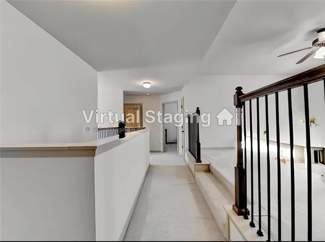 a view of a kitchen with a refrigerator a stove top oven and white cabinets