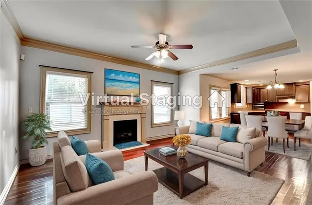 a living room with furniture fireplace and a large window