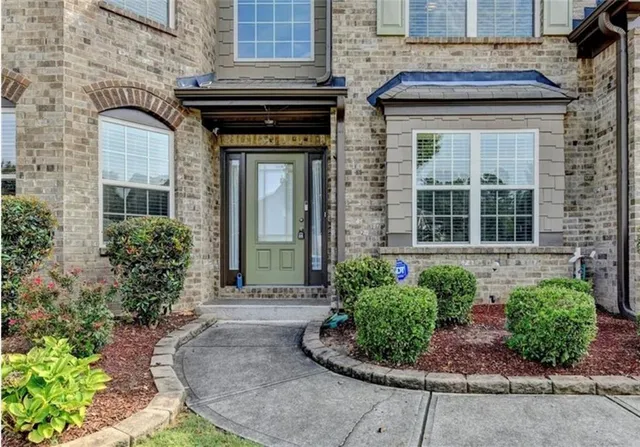 a front view of a house with garden