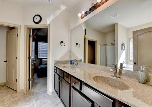 a bathroom with double vanity and a sink