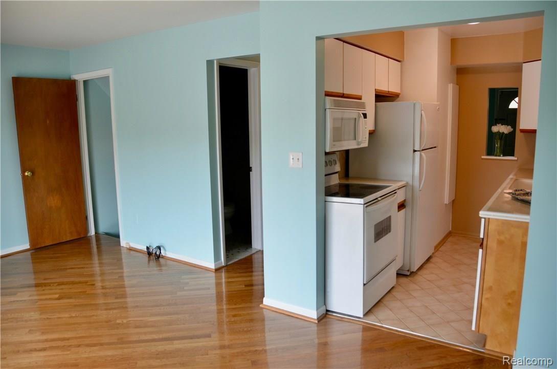6681 Andersonville Road, Unit 28 Clarkston, MI 48346 - Photo 9 of 22 Beautiful hardwood floors.Great Room looking toward kitchen