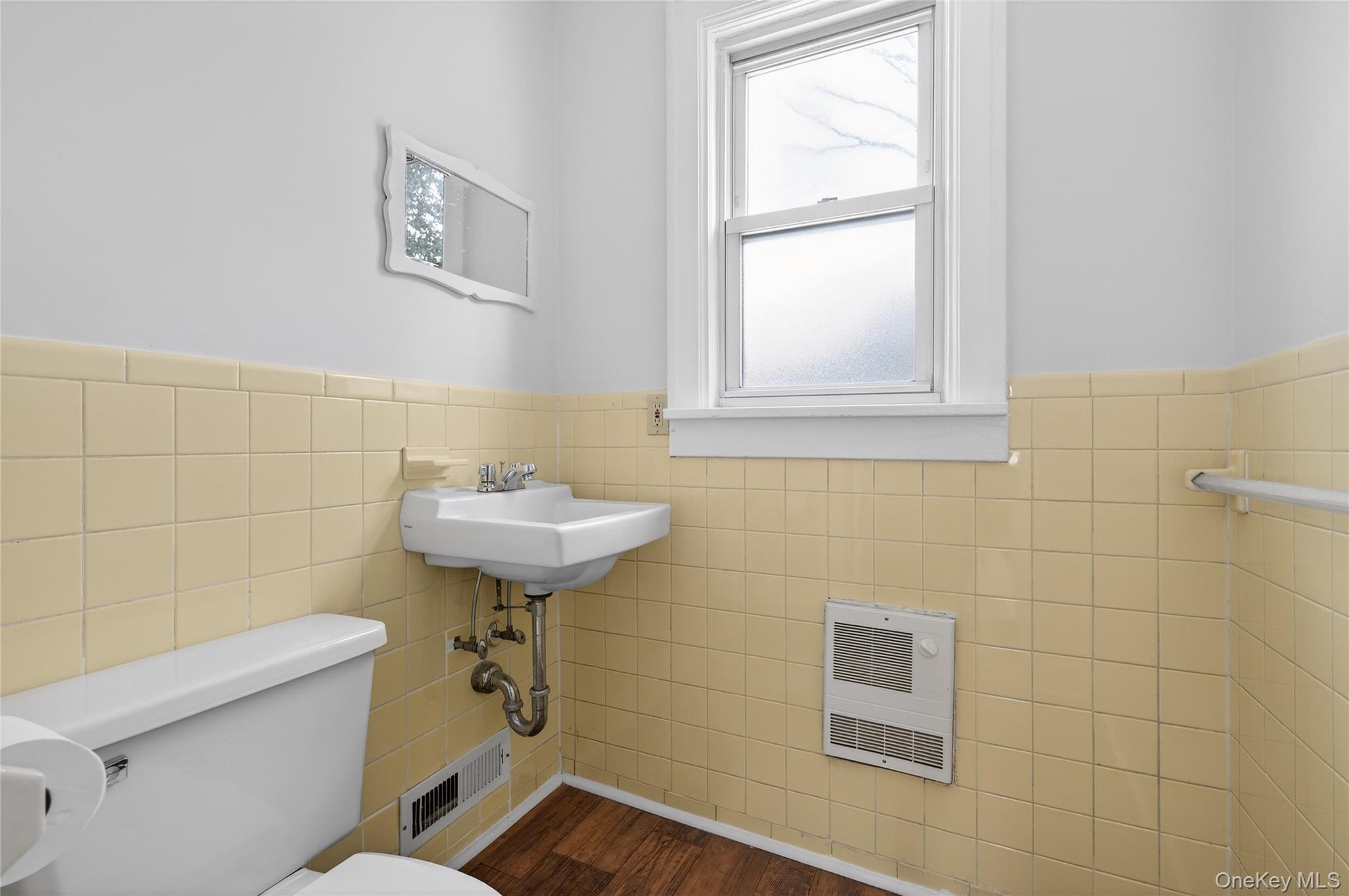 26 West 5th Street Locust Valley, NY 11560 - Photo 12 of 36 a bathroom with a sink a toilet and a window