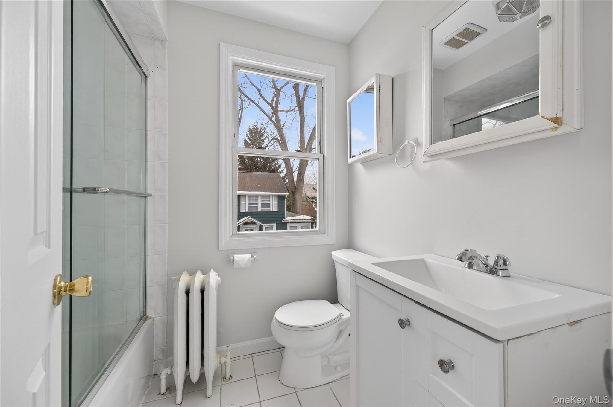 26 West 5th Street Locust Valley, NY 11560 - Photo 14 of 36 a bathroom with a toilet sink and mirror