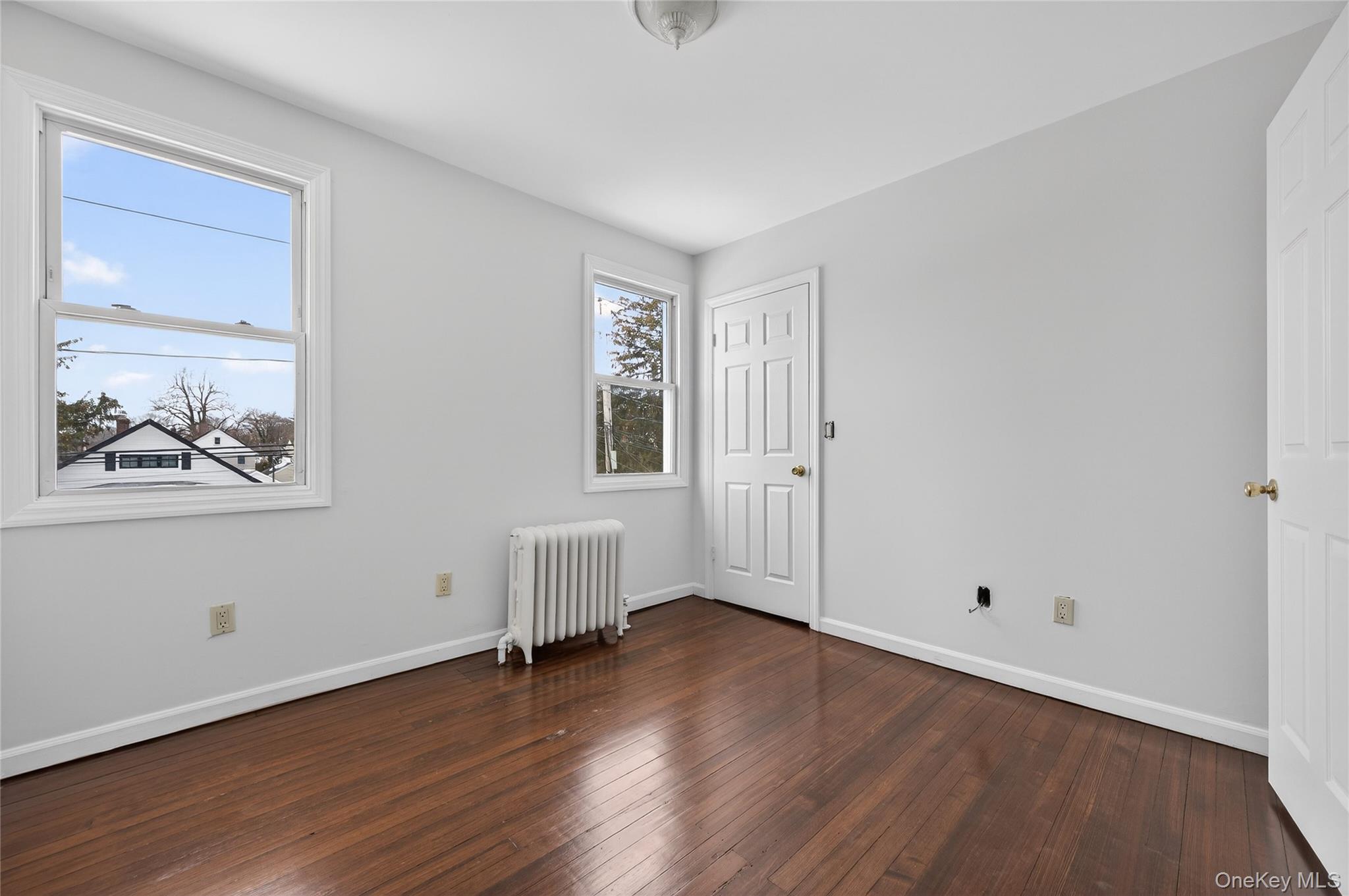 26 West 5th Street Locust Valley, NY 11560 - Photo 15 of 36 a view of empty room with wooden floor and fan