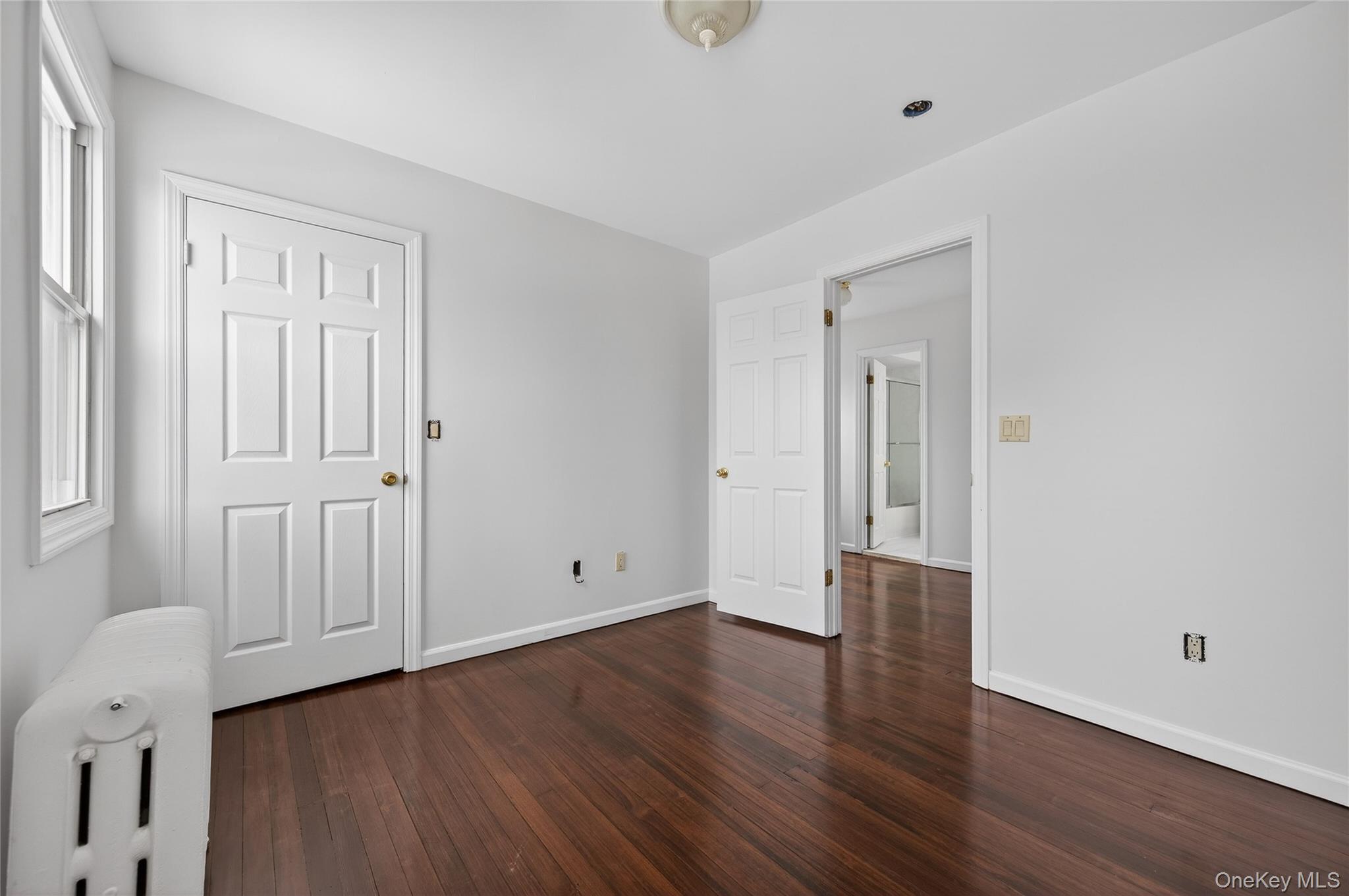 26 West 5th Street Locust Valley, NY 11560 - Photo 16 of 36 a view of an empty room with wooden floor
