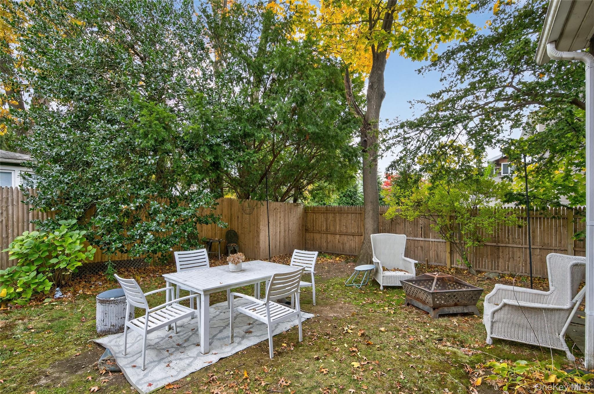 26 West 5th Street Locust Valley, NY 11560 - Photo 21 of 36 a view of a chairs and table in the back yard of the house