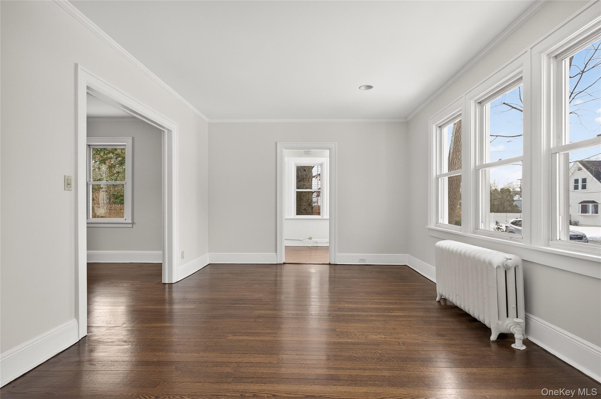 26 West 5th Street Locust Valley, NY 11560 - Photo 3 of 36 an empty room with wooden floor and windows