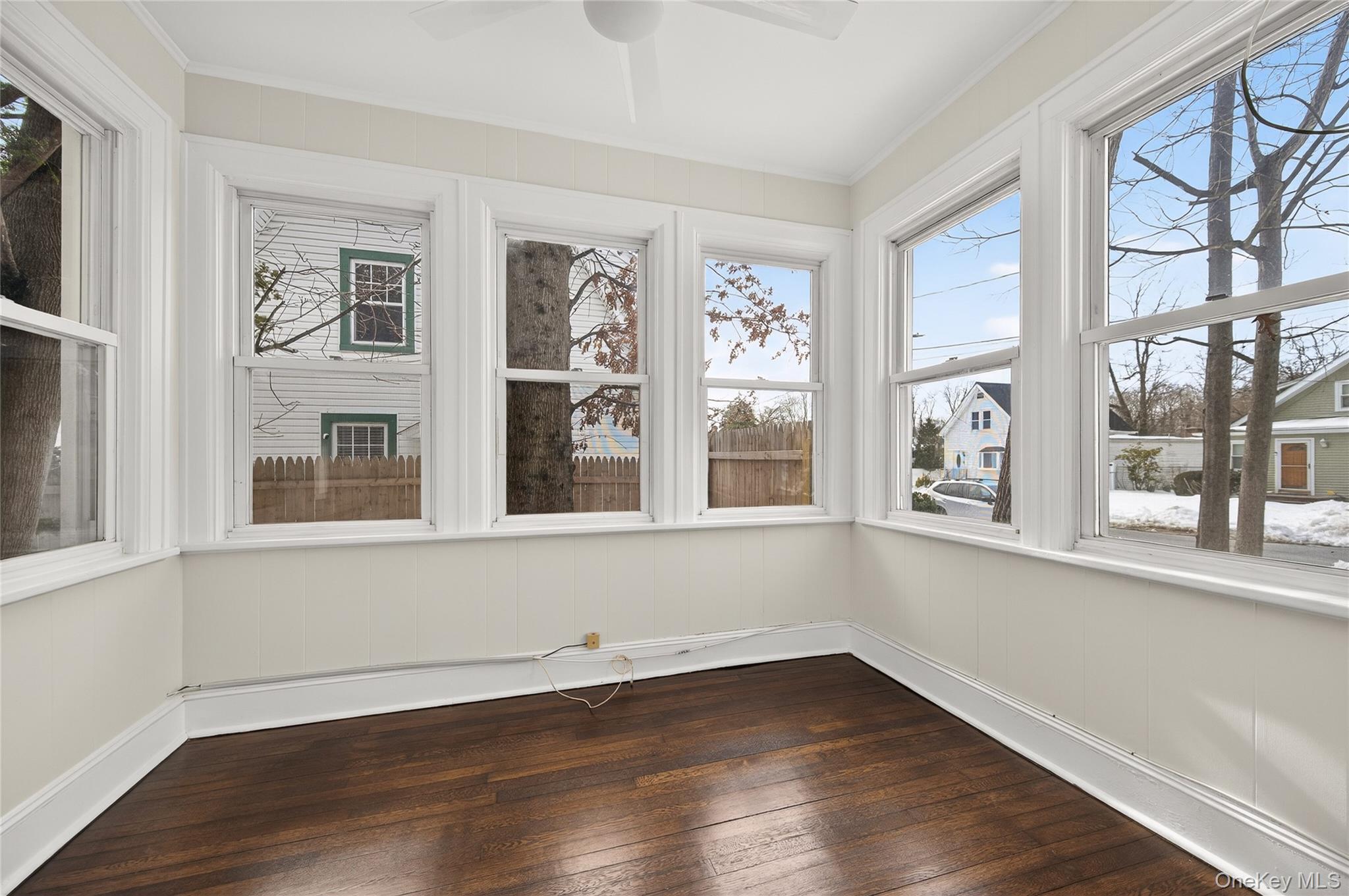 26 West 5th Street Locust Valley, NY 11560 - Photo 4 of 36 a view of an empty room with wooden floor and a window