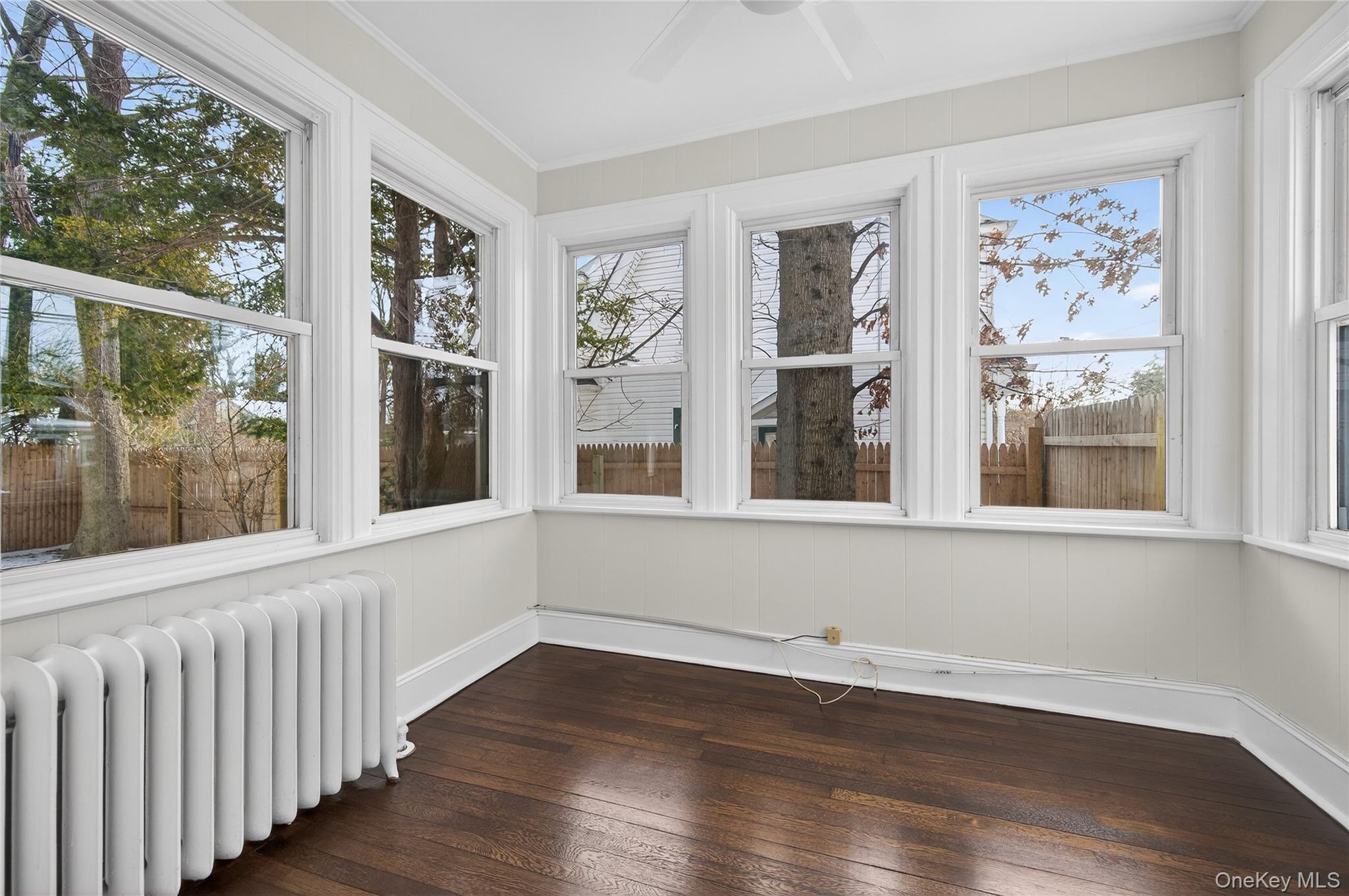 26 West 5th Street Locust Valley, NY 11560 - Photo 5 of 36 a view of an empty room with wooden floor and a window