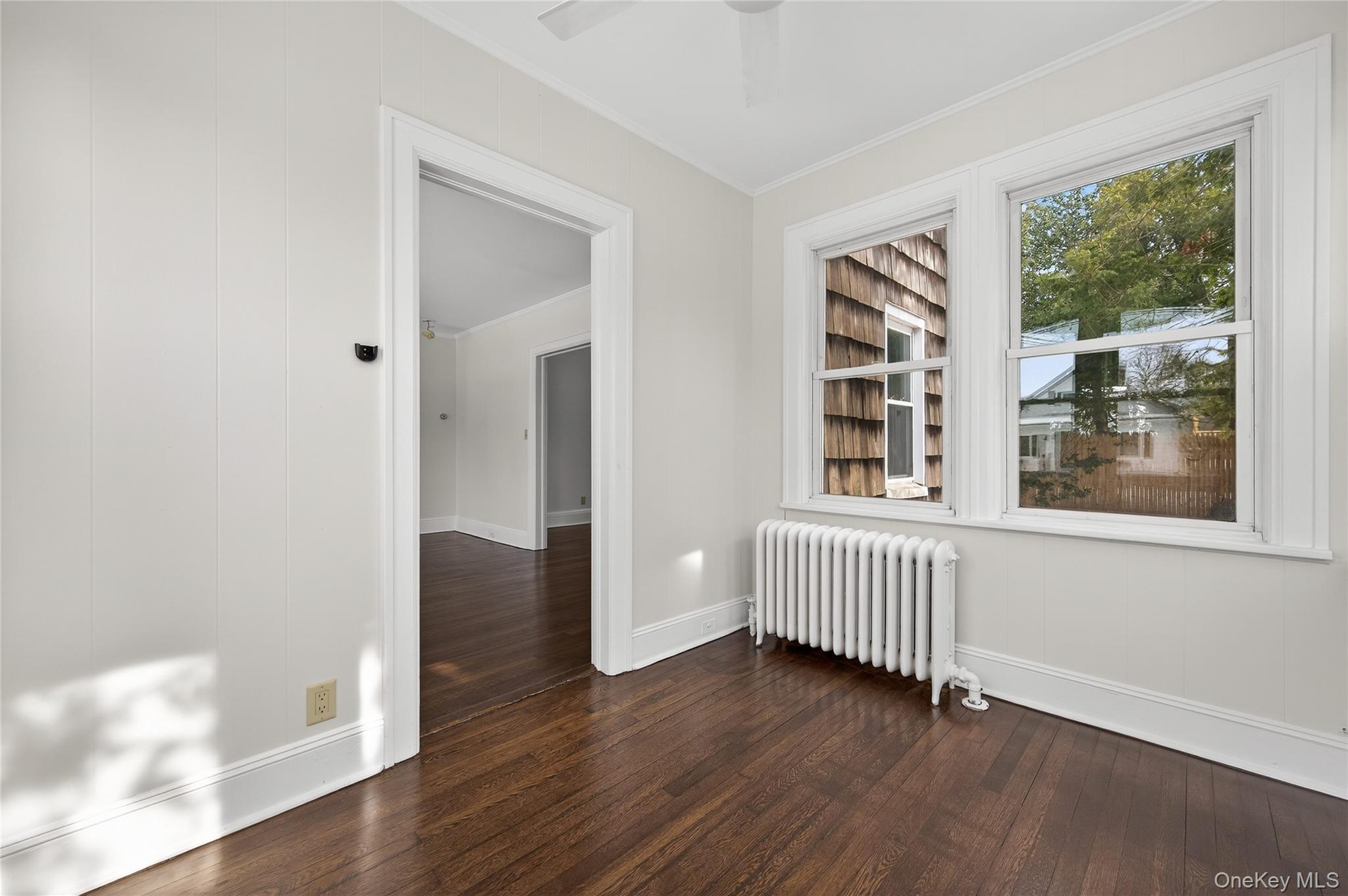 26 West 5th Street Locust Valley, NY 11560 - Photo 6 of 36 a view of an empty room with wooden floor and windows