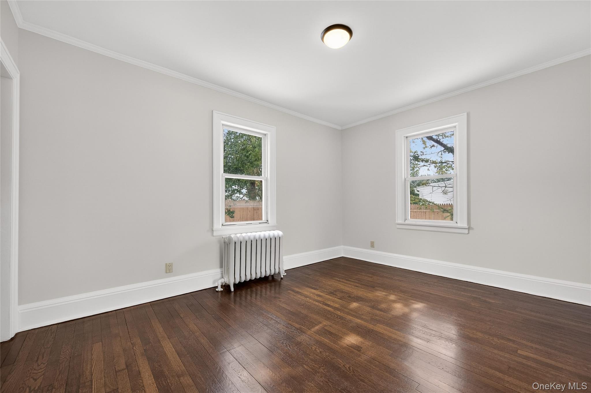 26 West 5th Street Locust Valley, NY 11560 - Photo 7 of 36 an empty room with wooden floor and windows