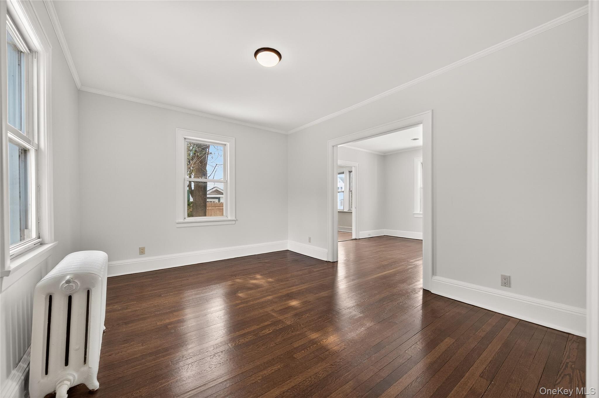 26 West 5th Street Locust Valley, NY 11560 - Photo 9 of 36 an empty room with wooden floor and windows