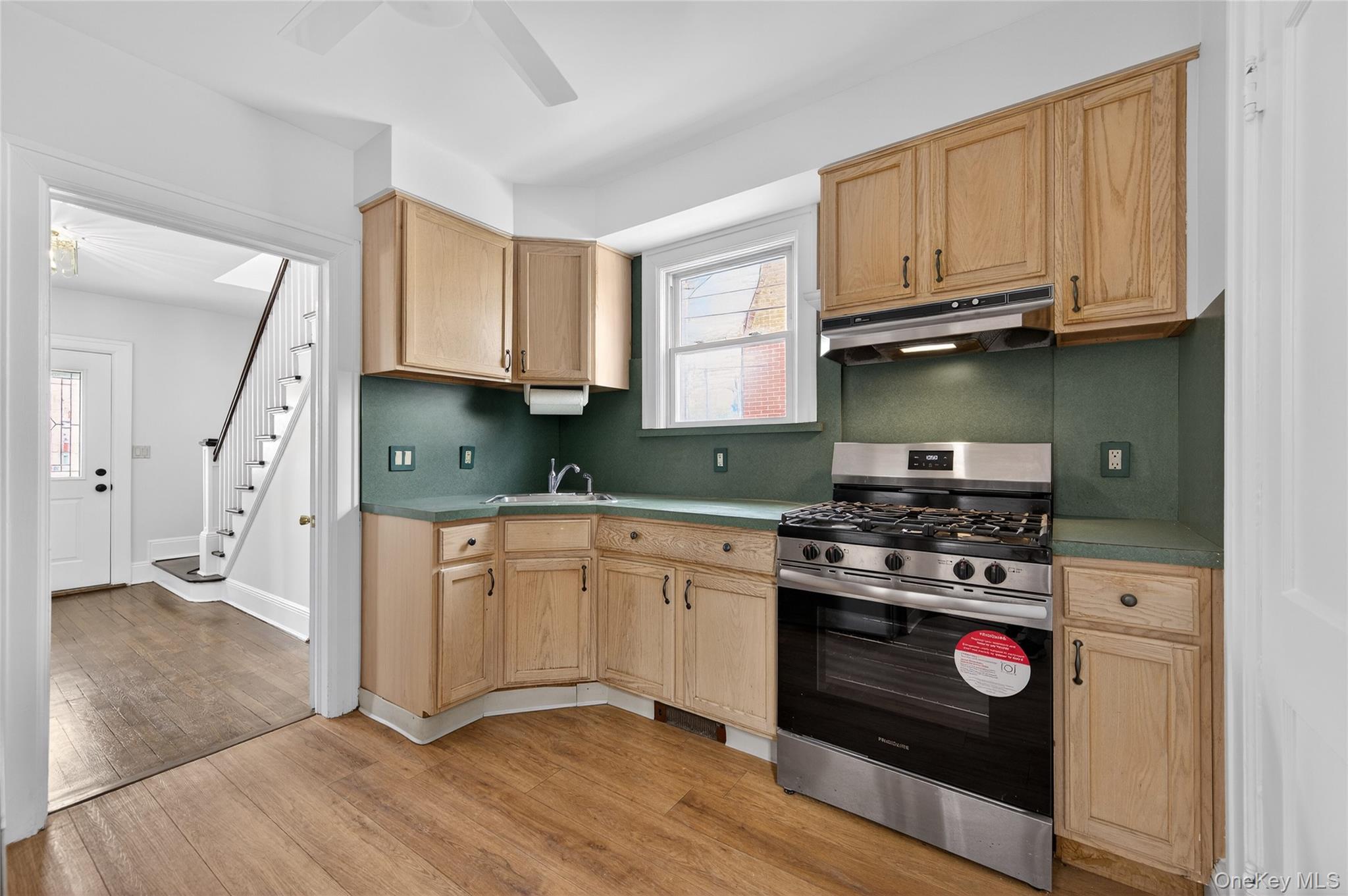 26 West 5th Street Locust Valley, NY 11560 - Photo 10 of 36 a kitchen with stainless steel appliances granite countertop a stove a sink and a microwave