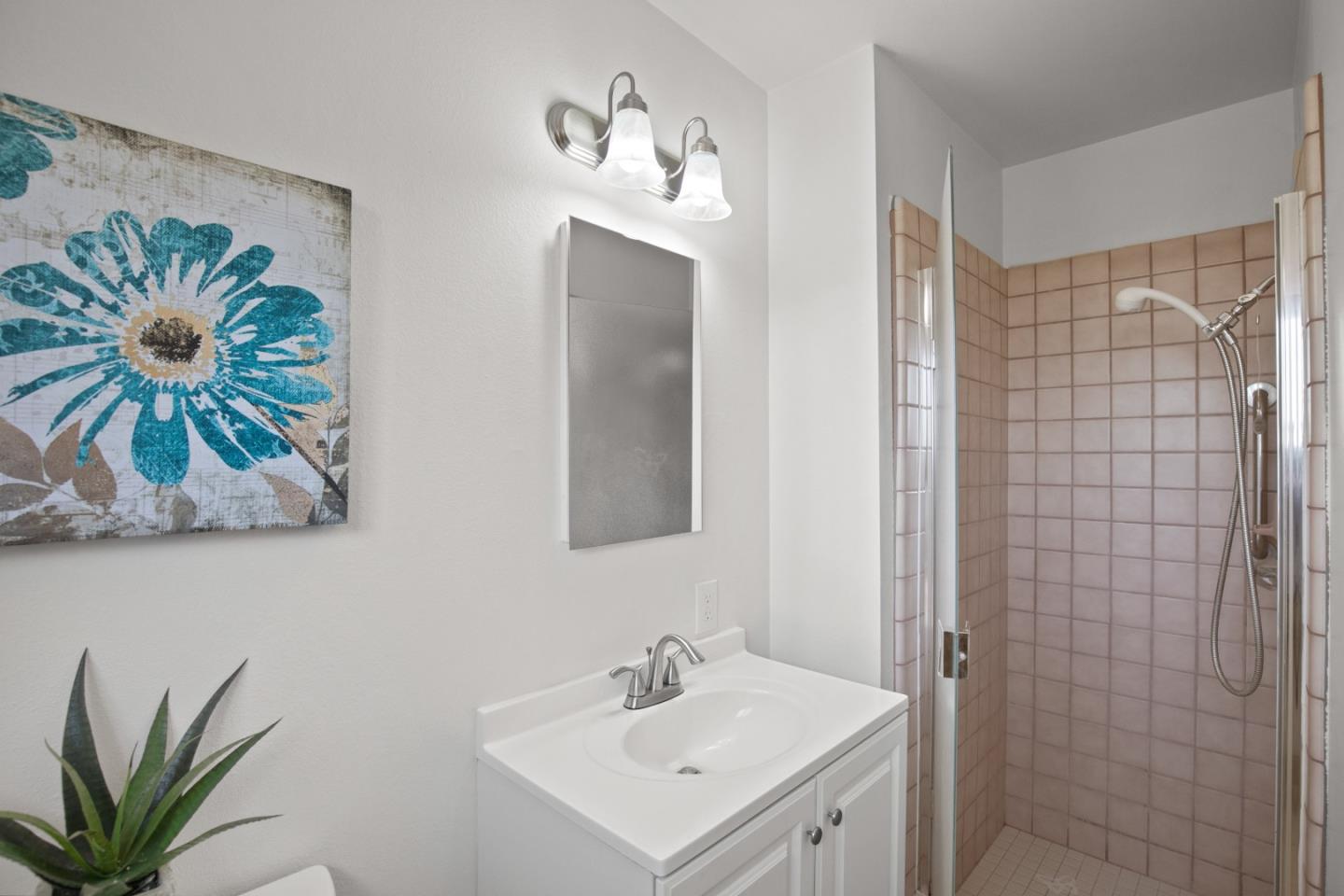 502 Ridgeview Avenue Marina, CA 93933 - Photo 11 of 20 a bathroom with a sink a mirror and a shower curtain