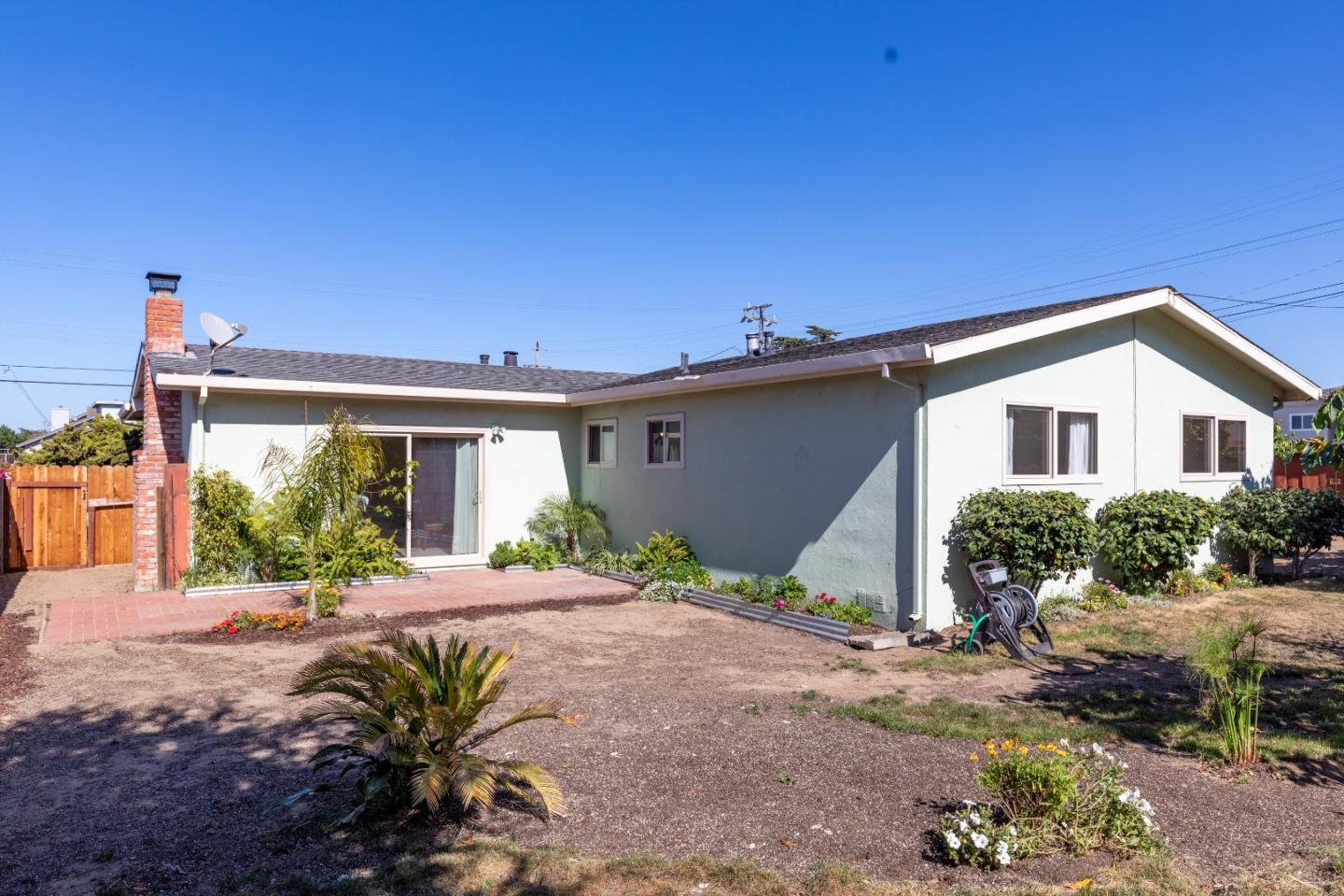 502 Ridgeview Avenue Marina, CA 93933 - Photo 19 of 20 a view of a house with wooden floor and a table and chairs under an umbrella
