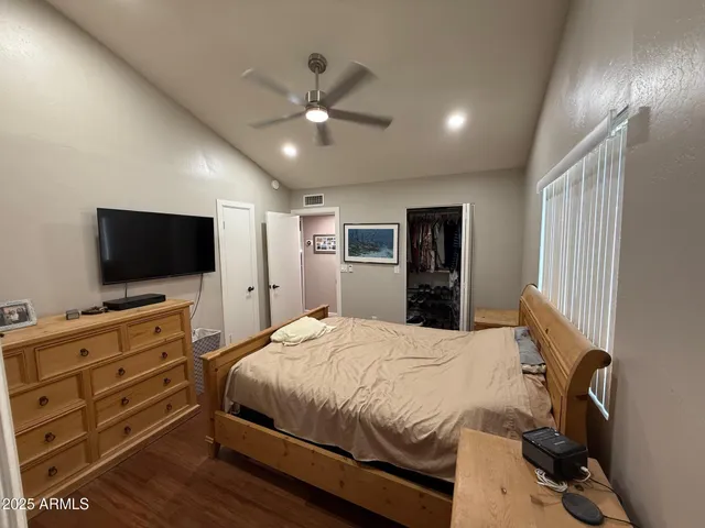 a bedroom with furniture and a mirror