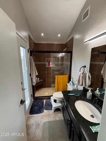a bathroom with a sink a toilet a mirror and vanity