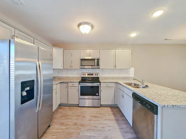 a kitchen with a sink stainless steel appliances and cabinets