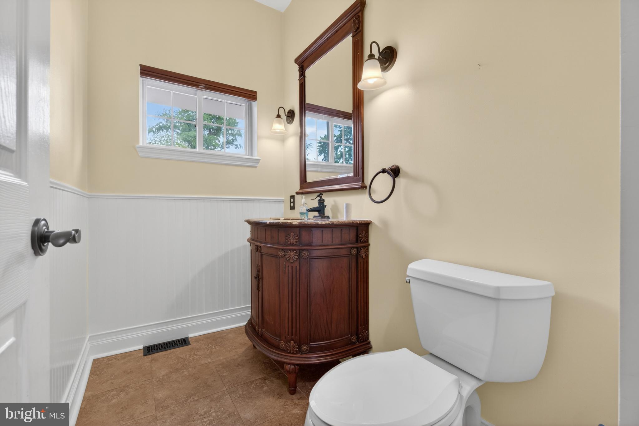 117 State Avenue Lindenwold, NJ 08021 - Photo 40 of 58 a white toilet sitting next to a bathroom sink and vanity