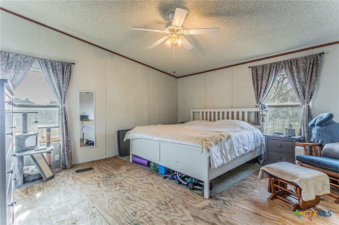 2811 Mimosa Drive Kempner, TX 76539 - Photo 12 of 27 a spacious bedroom with a bed and a chandelier