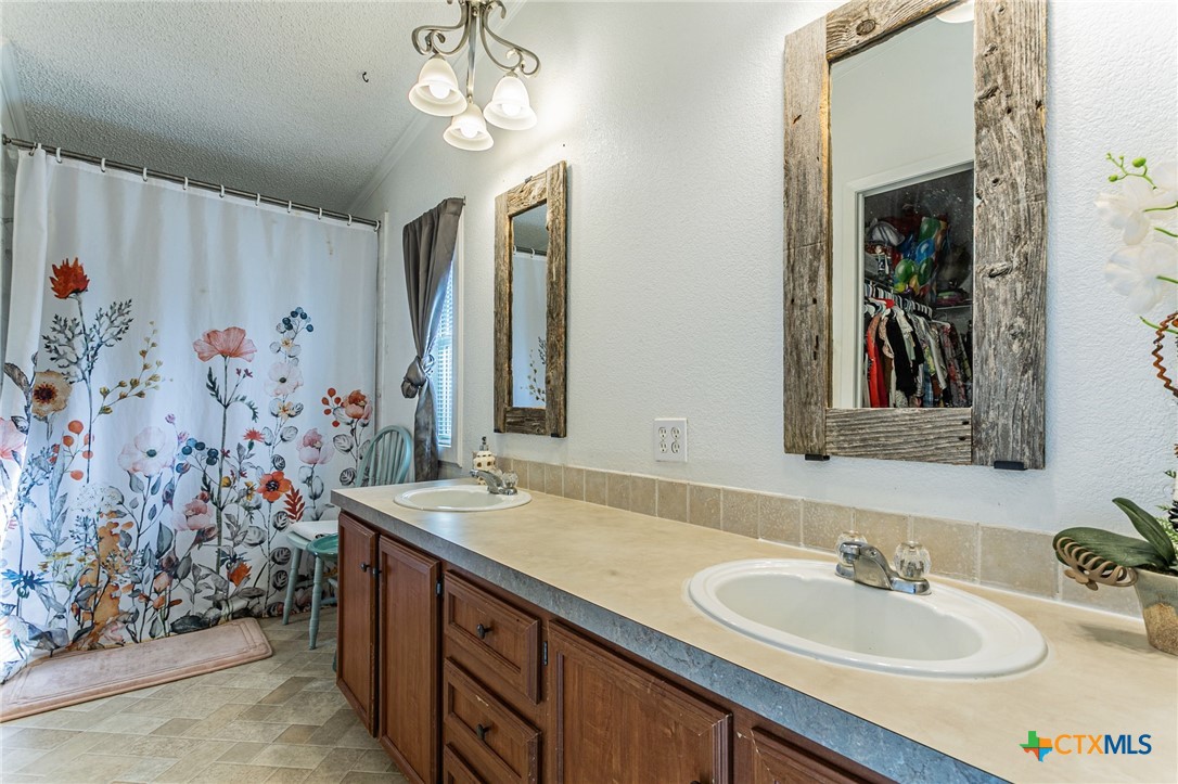 2811 Mimosa Drive Kempner, TX 76539 - Photo 13 of 27 a bathroom with a sink and a mirror