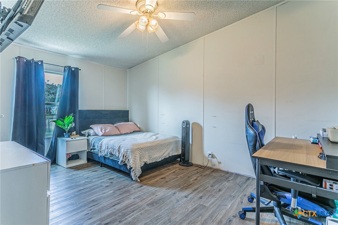 2811 Mimosa Drive Kempner, TX 76539 - Photo 18 of 27 a bedroom with furniture and a wooden floor