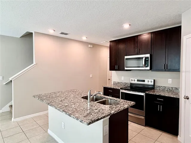 a view of a kitchen with an empty space and a window