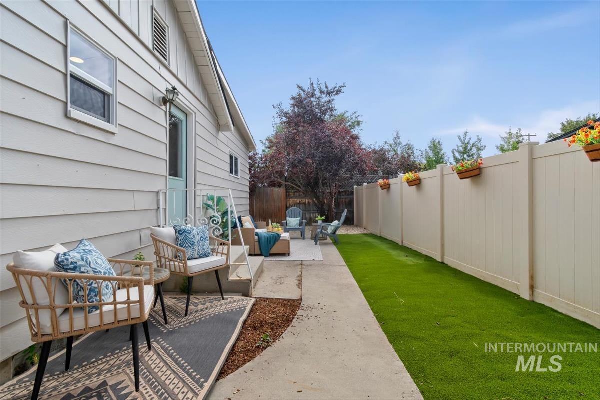 3005 West Hester Street Boise, ID 83702 - Photo 30 of 32 Private outdoor living area featuring a concrete patio, artificial turf, and a light-colored privacy fence