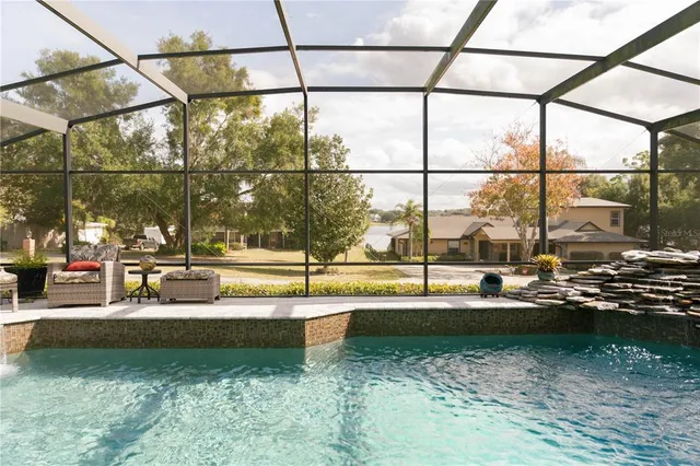 a view of a swimming pool with a yard