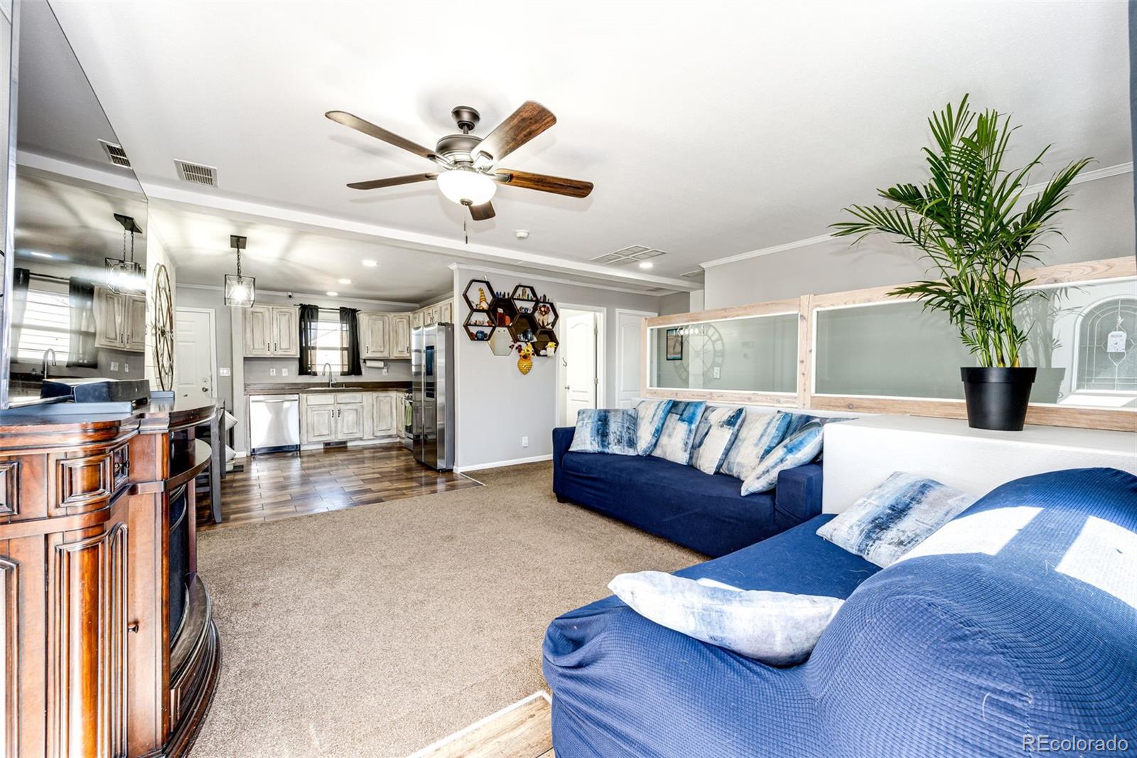 570 4th Street Bennett, CO 80102 - Photo 6 of 36 a living room with furniture and kitchen view