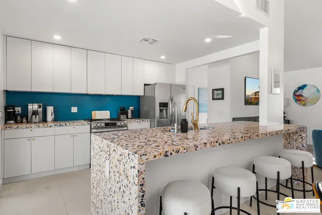 a bedroom with a bed and a painting on the wall