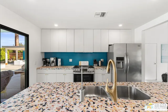 a bedroom with a bed and a painting on the wall