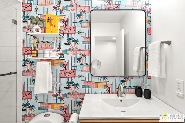 a bedroom with a bed and a painting on the wall