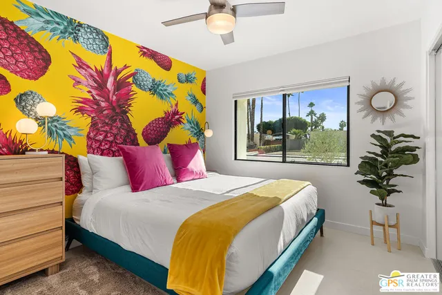 a bedroom with a large bed and a chandelier