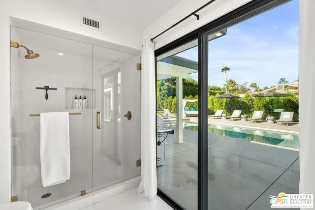 a view of swimming pool with outdoor seating and plants