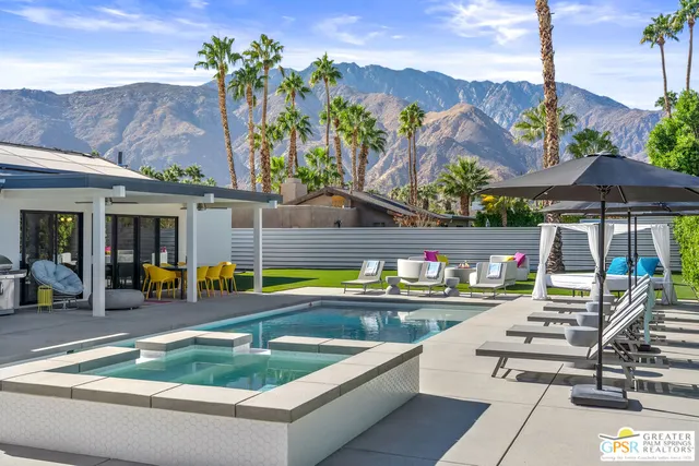 a view of swimming pool with outdoor seating and city view