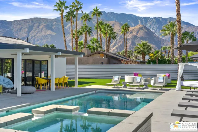a view of a house with swimming pool and porch