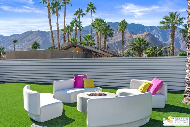 a view of a porch with furniture and a yard