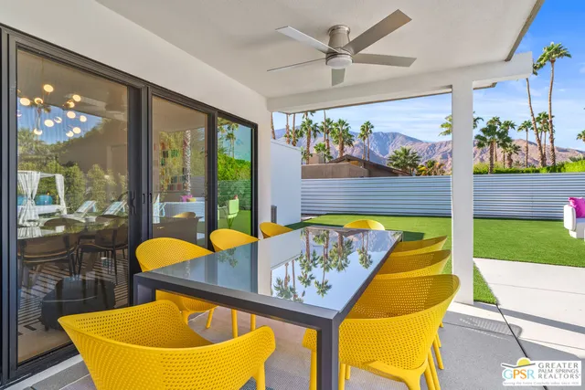 a view of a patio with a table chairs and a fire pit