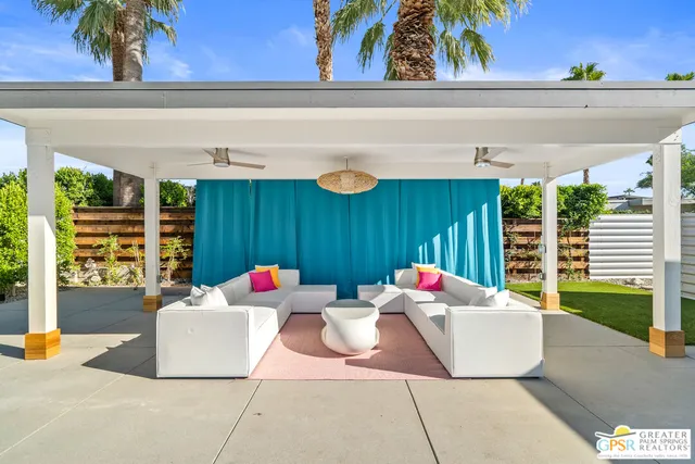 a view of a house with backyard outdoor seating area and furniture