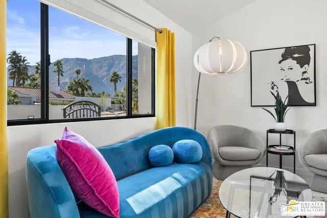 a living room with furniture potted plant and a window