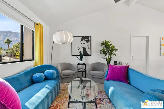 a living room with furniture flowers and a chandelier