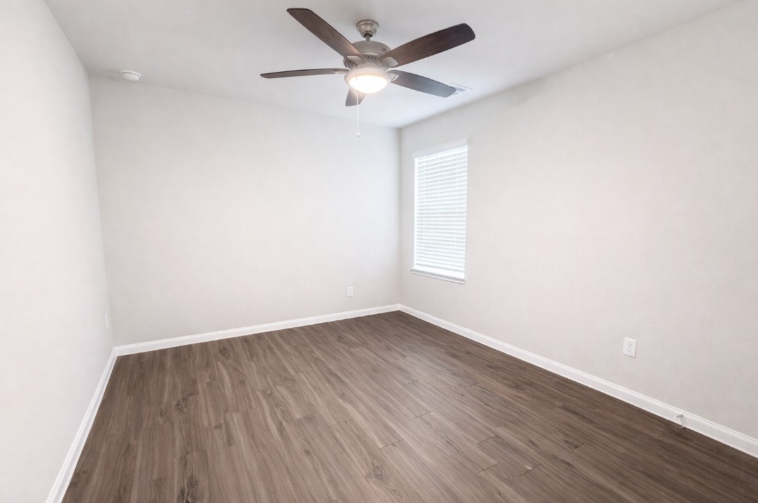 5127 Shelby Katherine Drive Rosharon, TX 77583 - Photo 11 of 12 an empty room with wooden floor and windows