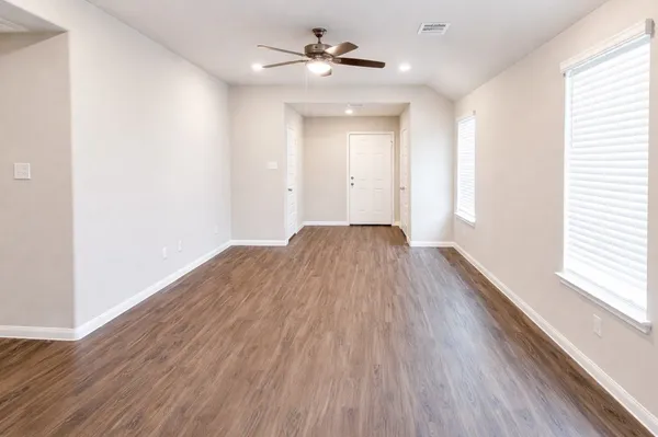 wooden floor in an empty room with a window