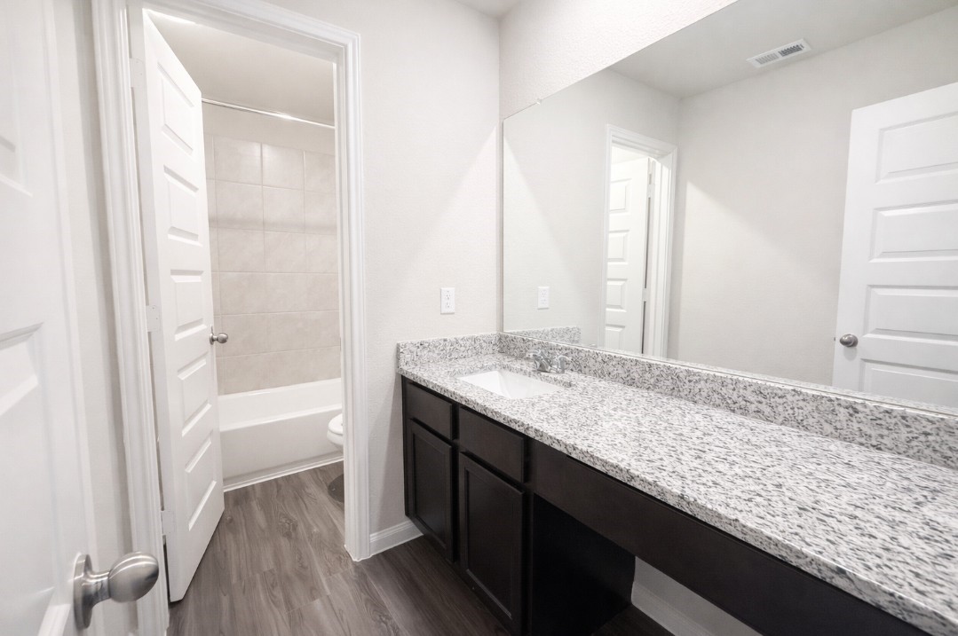 5127 Shelby Katherine Drive Rosharon, TX 77583 - Photo 10 of 12 a bathroom with a granite countertop sink and a bathtub