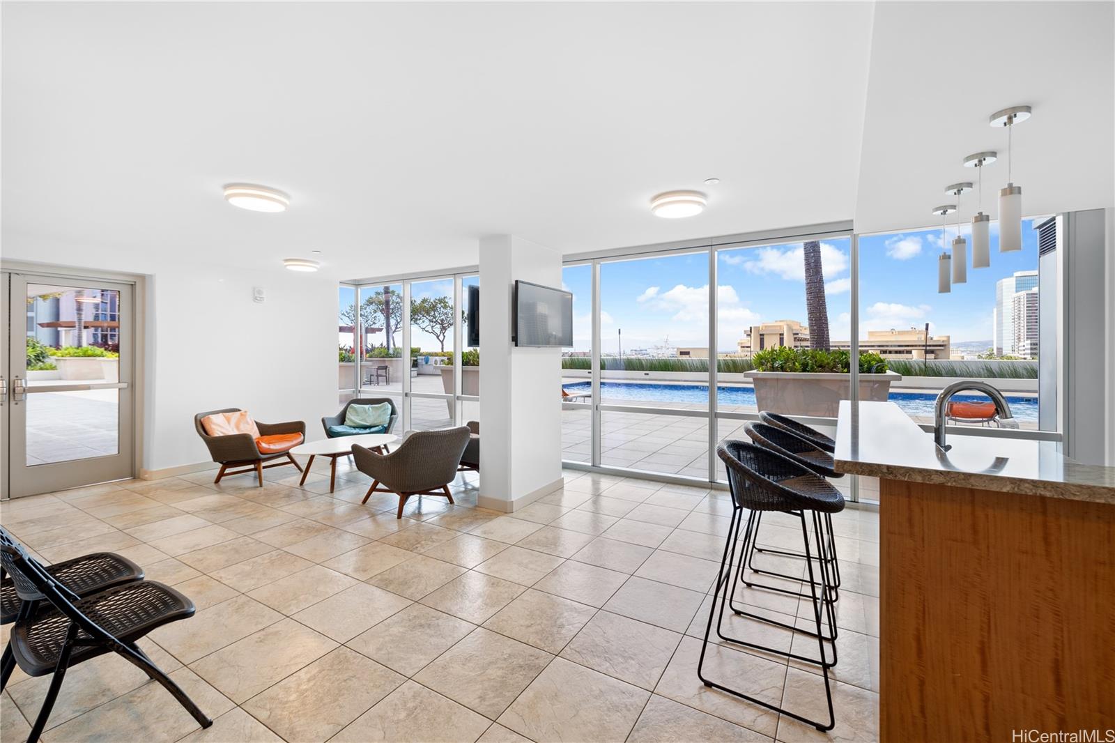 555 South Street, Unit 1805 Honolulu, HI 96813 - Photo 18 of 20 a kitchen with a dining table chairs and white appliances
